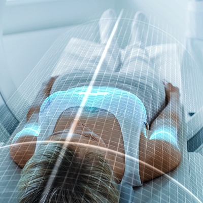 Person laying in a body imaging machine