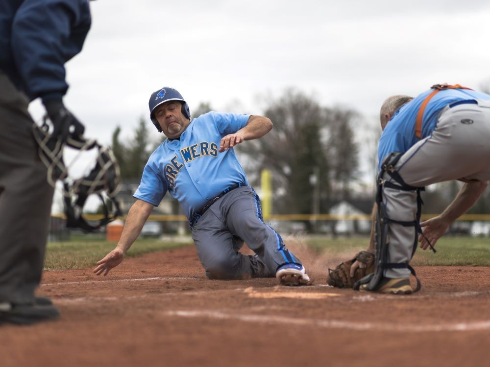 John sliding into home plate