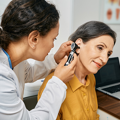 doctor checking patient's ears