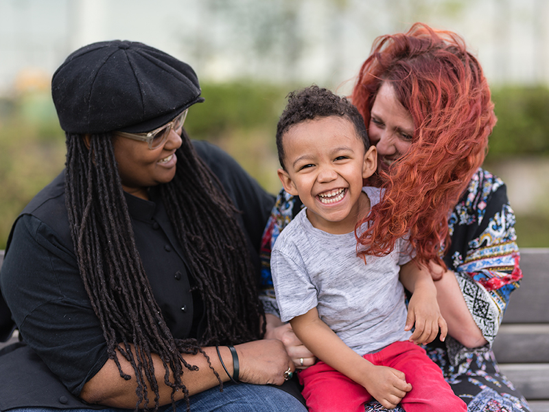 Diverse Pride Couple with child